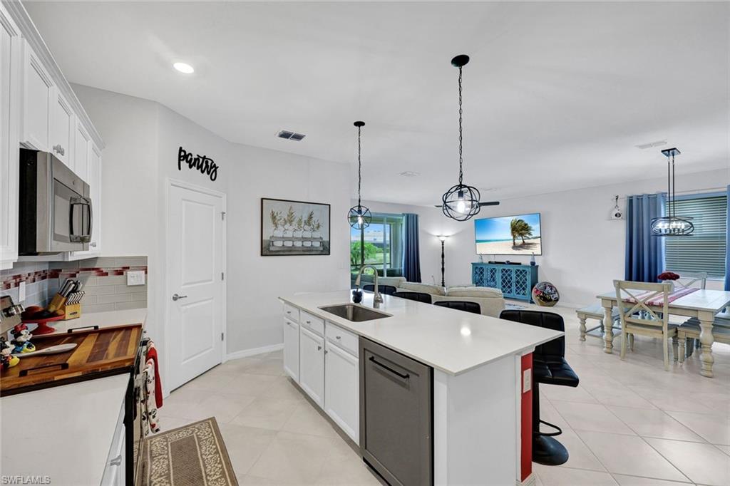 2622 Scarlet Way Naples, FL 34120 - Photo 6 of 24 a room with sink a with furniture and flat screen tv