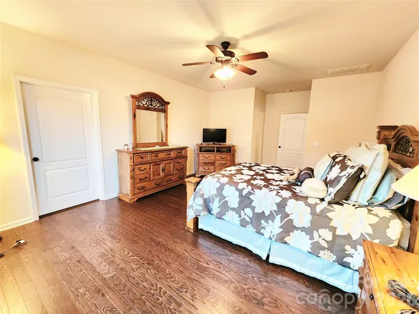 a bedroom with a bed and ceiling fan