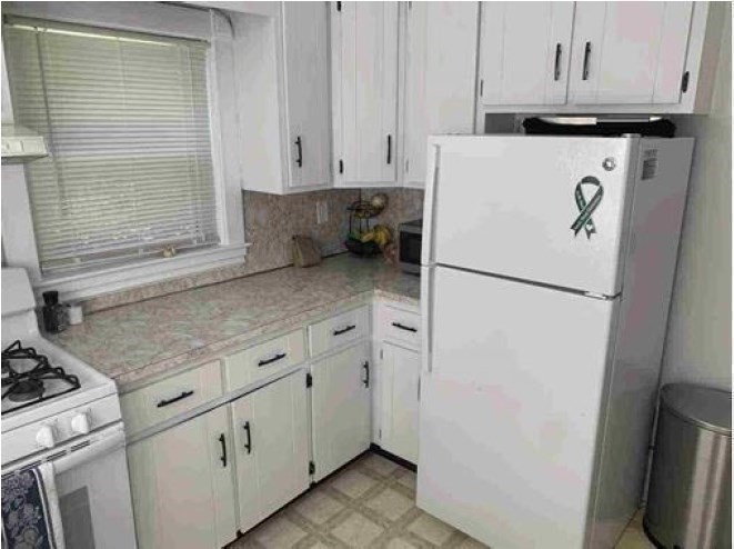 28 Beaconsfield Road, Unit 1 Brookline, MA 02445 - Photo 8 of 21 a kitchen with stainless steel appliances white cabinets and a refrigerator