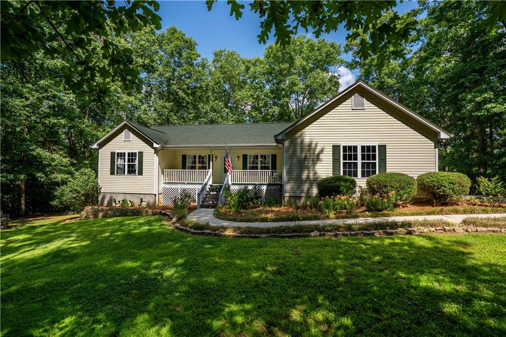 5584 Northwoods Road Clermont, GA 30527 - Photo 1 of 1 a front view of a house with a yard