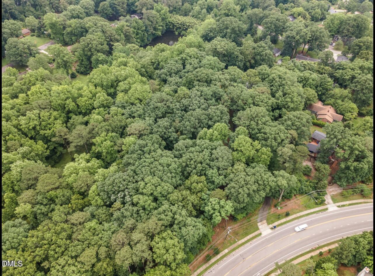 517 Buck Jones Road Raleigh, NC 27606 - Photo 4 of 6 an aerial view of residential houses with outdoor space and trees