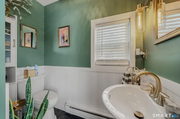 a bathroom with a sink a toilet and a mirror