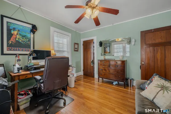 a view of a workspace with furniture and a window