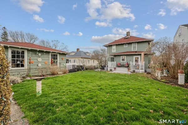 a view of an house with backyard space and balcony