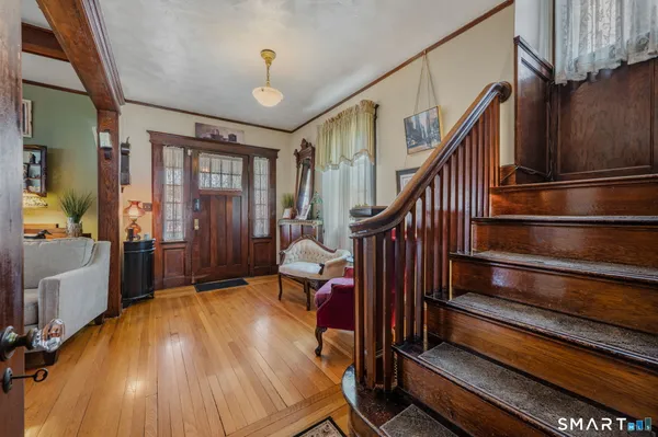 a view of entryway and hall with wooden floor