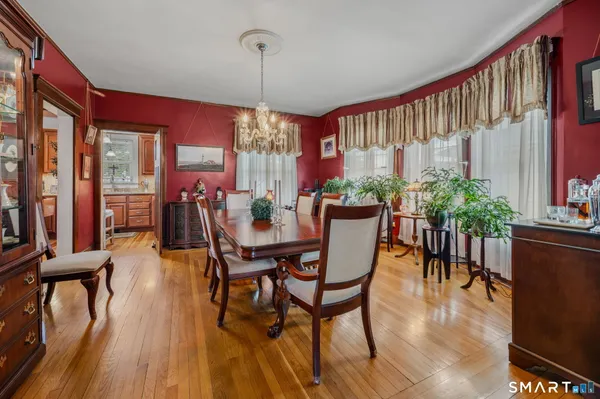 a view of a dining room with furniture window and wooden floor