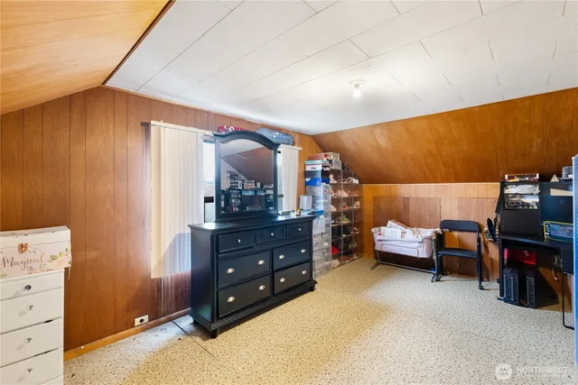 a kitchen with a sink stove cabinets and wooden floor