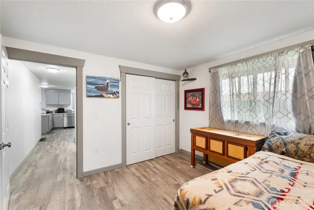 aerial view of a house with a yard and lake view