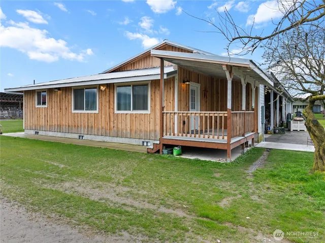 a view of a house with a yard and deck