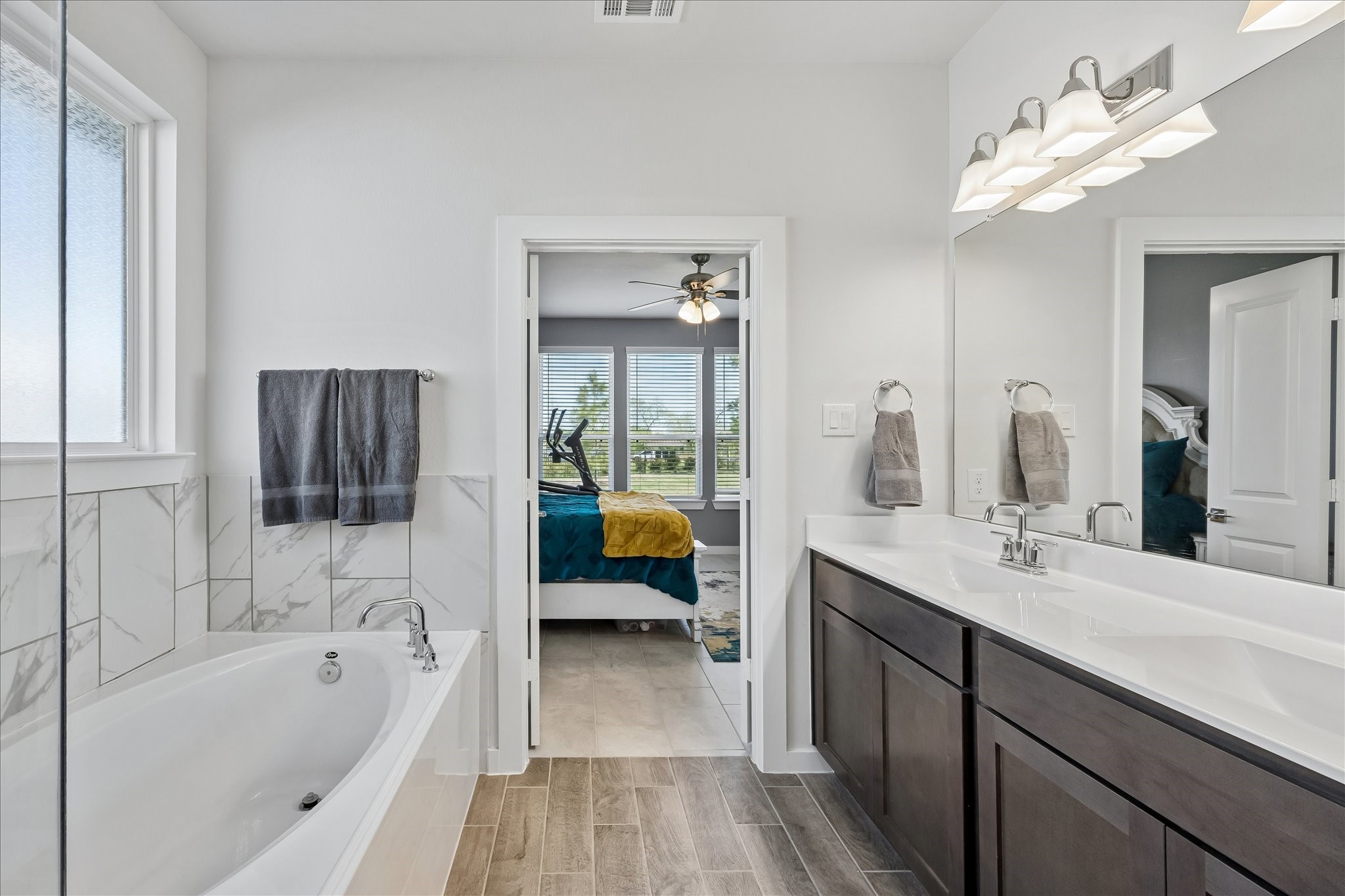 33002 Carolyns Perfection Loop Fulshear, TX 77441 - Photo 18 of 29 a en suite bathroom with a tub double sink and mirror