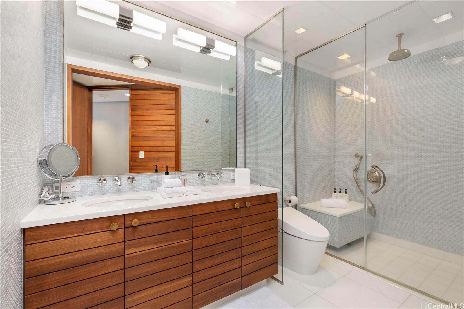 223 Saratoga Road, Unit PHD Honolulu, HI 96815 - Photo 19 of 25 a bathroom with a double vanity sink mirror and toilet