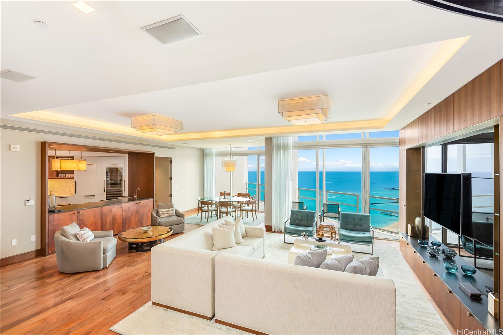 223 Saratoga Road, Unit PHD Honolulu, HI 96815 - Photo 2 of 25 a living room with furniture and a flat screen tv