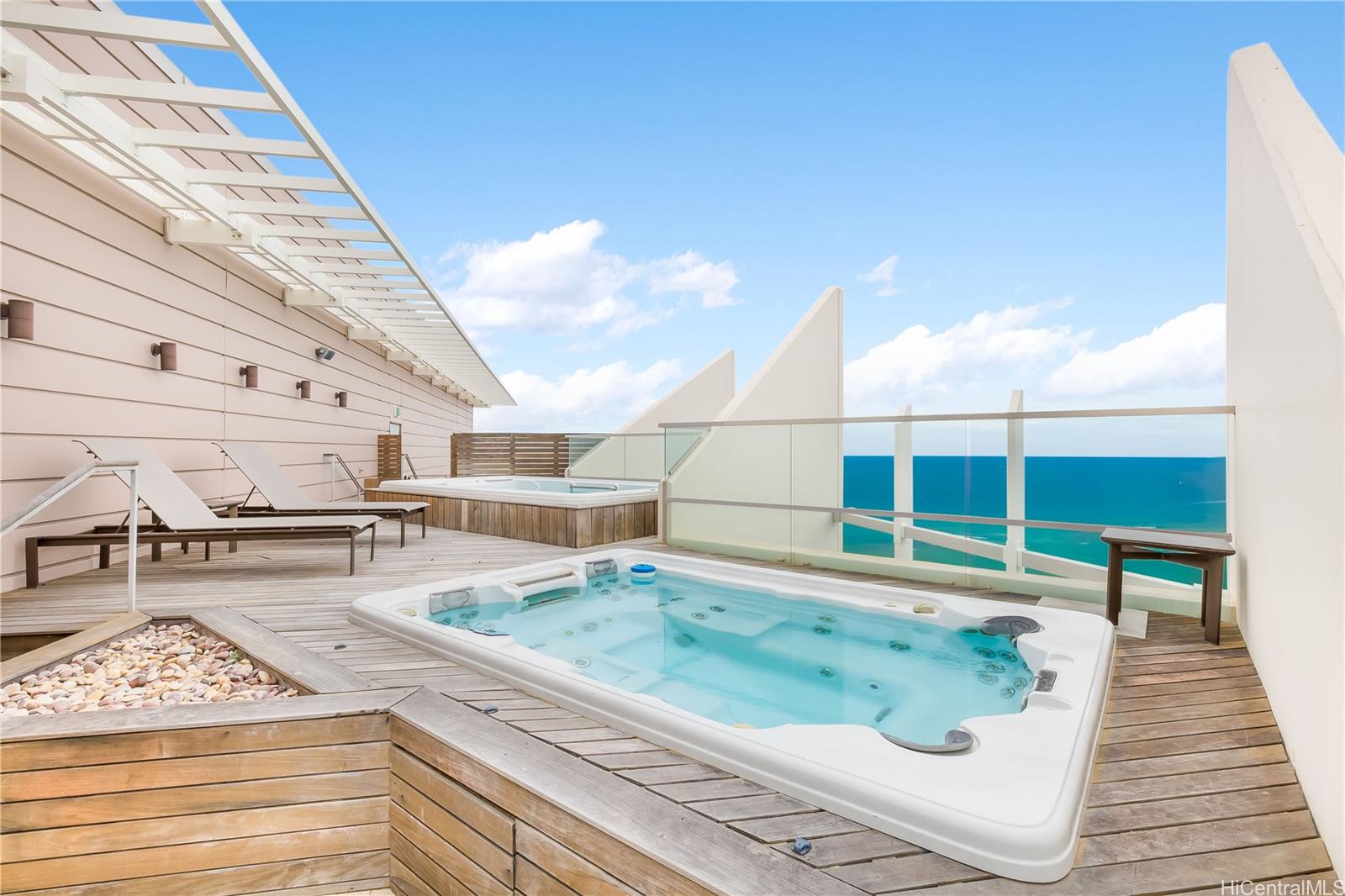 223 Saratoga Road, Unit PHD Honolulu, HI 96815 - Photo 21 of 25 a view of a swimming pool with a lounge chair