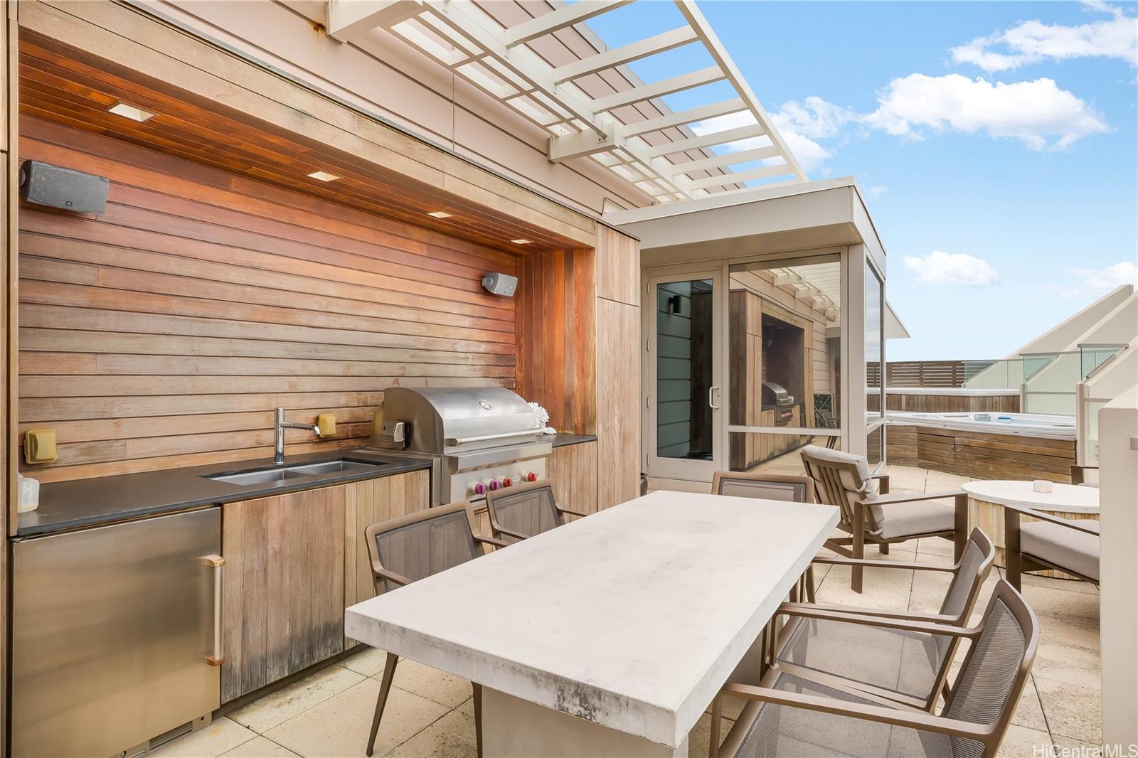 223 Saratoga Road, Unit PHD Honolulu, HI 96815 - Photo 23 of 25 a kitchen with a table chairs and a stove