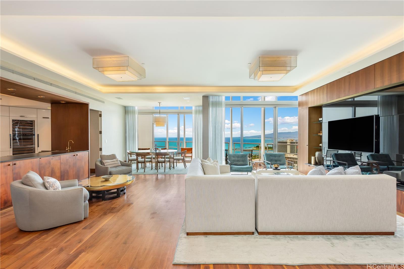 223 Saratoga Road, Unit PHD Honolulu, HI 96815 - Photo 3 of 25 a living room with furniture and a flat screen tv