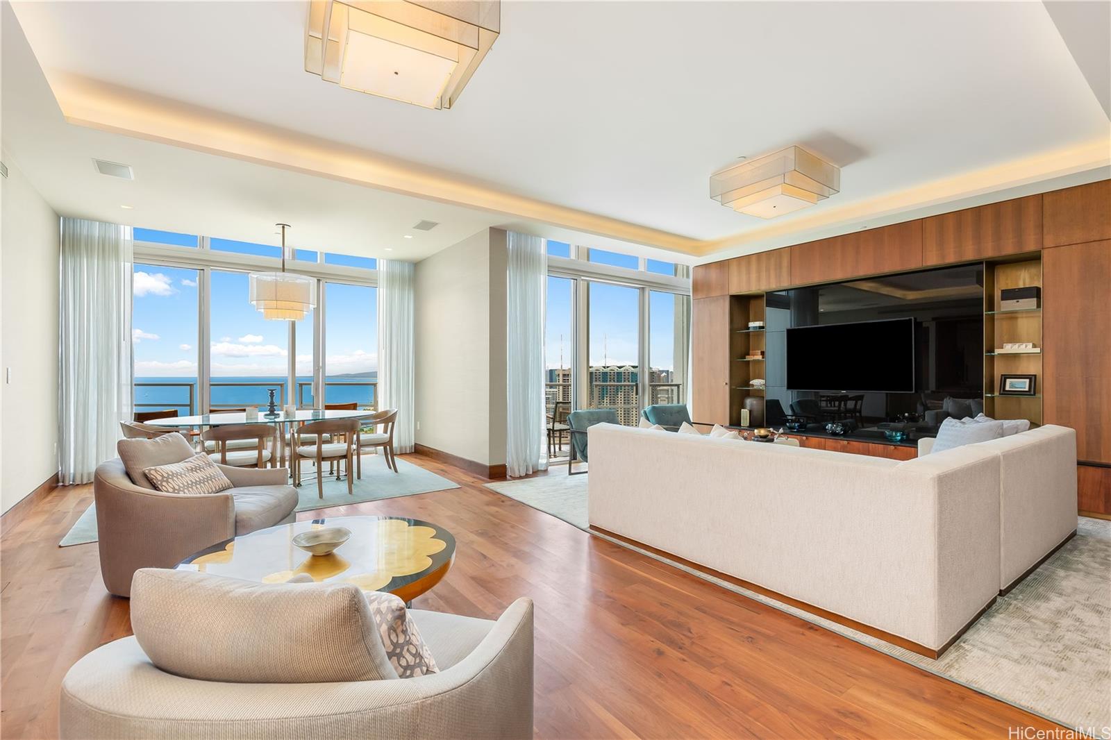 223 Saratoga Road, Unit PHD Honolulu, HI 96815 - Photo 4 of 25 a living room with furniture and a flat screen tv