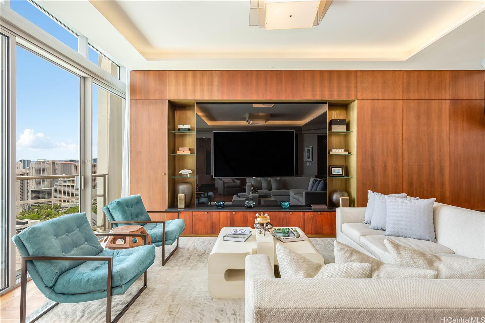 223 Saratoga Road, Unit PHD Honolulu, HI 96815 - Photo 5 of 25 a living room with furniture and a flat screen tv