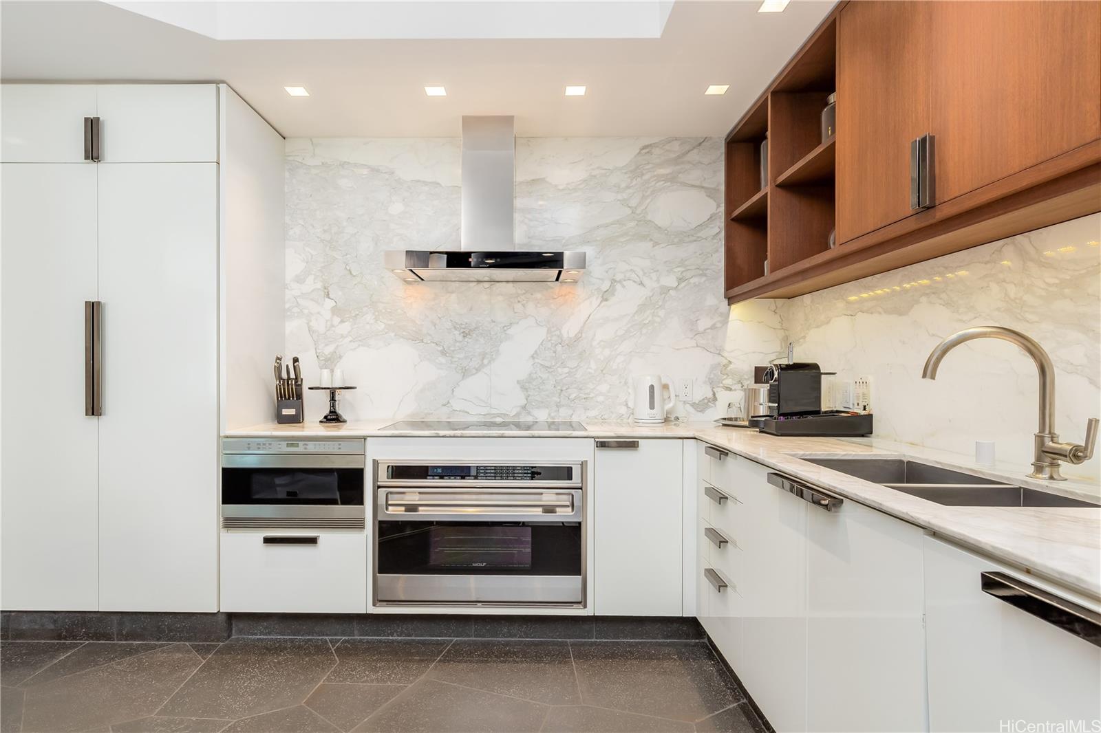 223 Saratoga Road, Unit PHD Honolulu, HI 96815 - Photo 9 of 25 a kitchen with stainless steel appliances granite countertop a stove a sink and a microwave