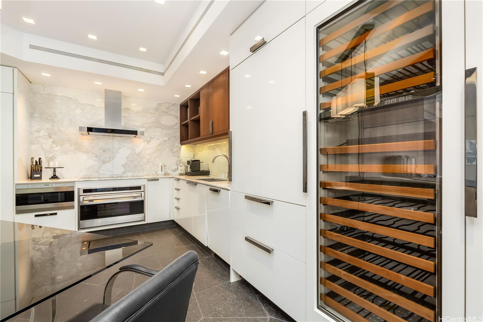 223 Saratoga Road, Unit PHD Honolulu, HI 96815 - Photo 10 of 25 a kitchen with a refrigerator and a window