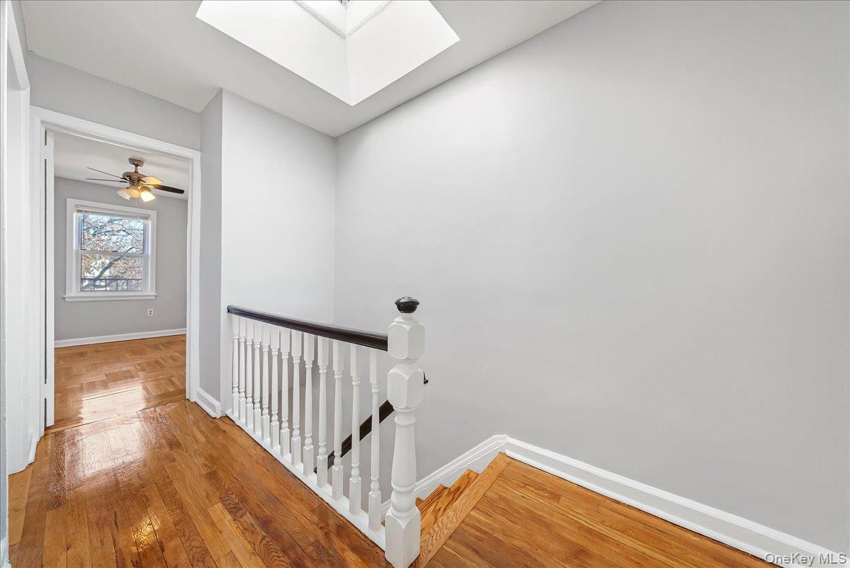 4309 Edson Avenue Bronx, NY 10466 - Photo 10 of 26 a view of a hallway with wooden floor and a bathroom