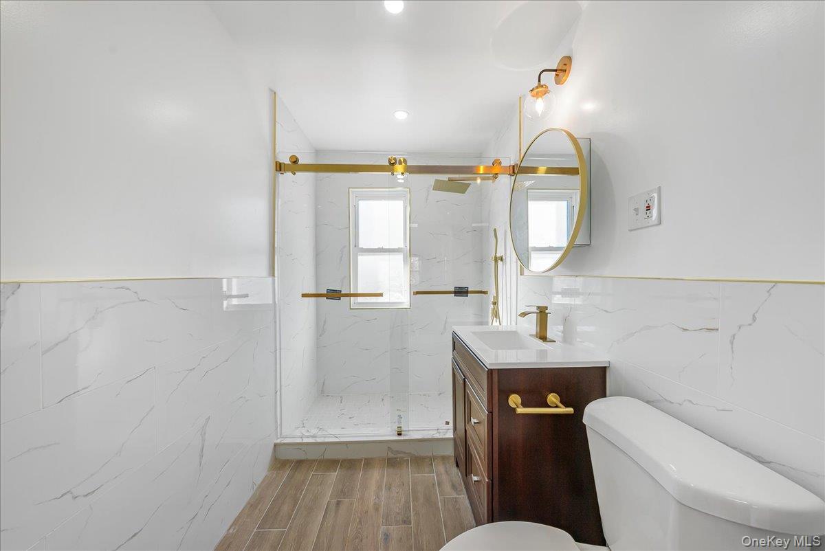 4309 Edson Avenue Bronx, NY 10466 - Photo 12 of 26 a bathroom with a toilet a sink and mirror