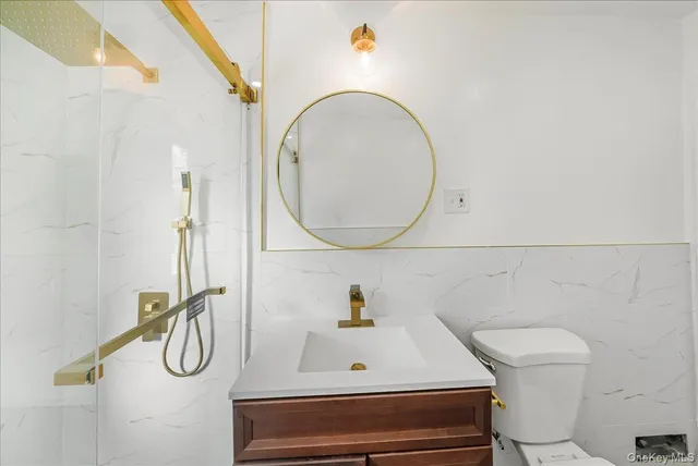 a bathroom with a toilet a sink and mirror