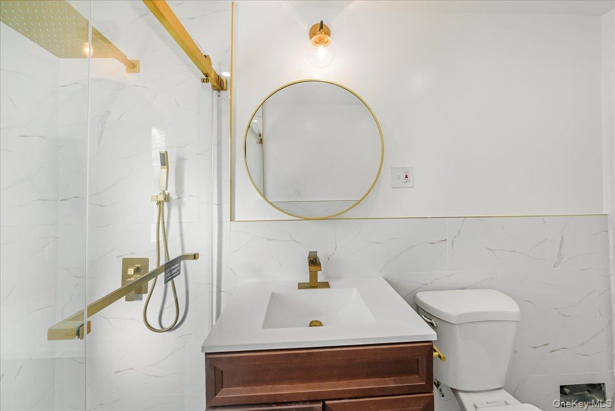 4309 Edson Avenue Bronx, NY 10466 - Photo 13 of 26 a bathroom with a sink a toilet and a mirror