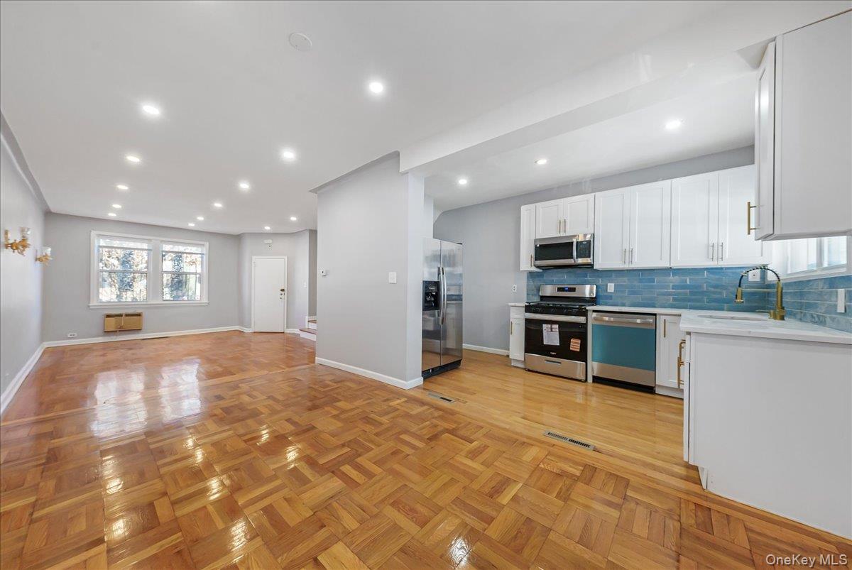 4309 Edson Avenue Bronx, NY 10466 - Photo 26 of 26 a large kitchen with stainless steel appliances granite countertop a large counter top and a stove top oven