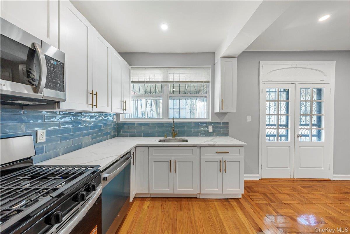 4309 Edson Avenue Bronx, NY 10466 - Photo 6 of 26 a kitchen with a stove and a sink