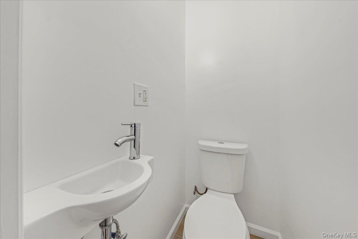 4309 Edson Avenue Bronx, NY 10466 - Photo 7 of 26 a bathroom with a sink a toilet and mirror