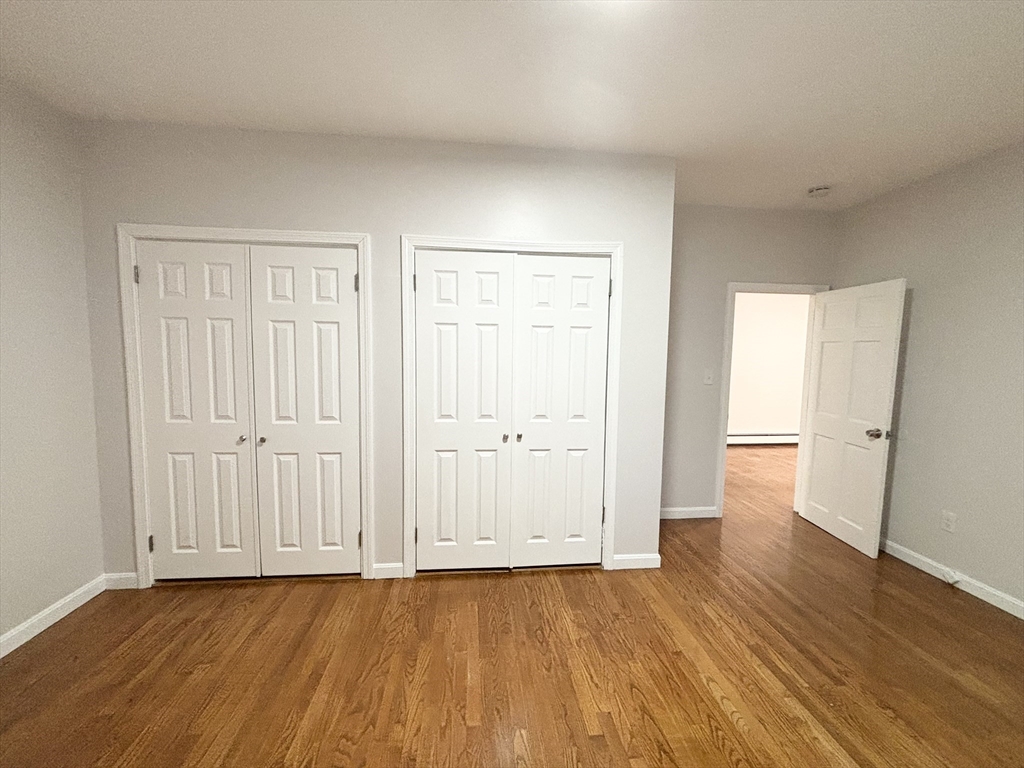 98 Main Street, Unit 1 Malden, MA 02148 - Photo 11 of 15 a view of an empty room with wooden floor