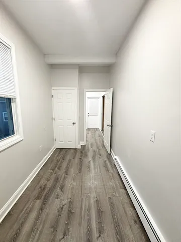 an empty room with wooden floor