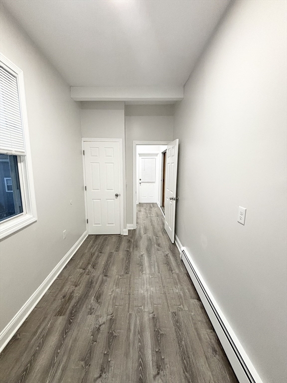 98 Main Street, Unit 1 Malden, MA 02148 - Photo 13 of 15 an empty room with wooden floor
