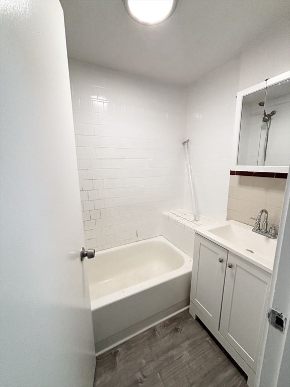 98 Main Street, Unit 1 Malden, MA 02148 - Photo 15 of 15 a bathroom with a sink a toilet and bathtub