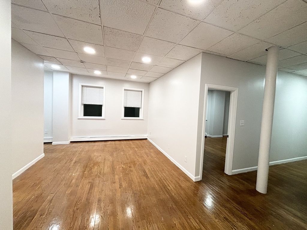 98 Main Street, Unit 1 Malden, MA 02148 - Photo 3 of 15 a view of an empty room with wooden floor