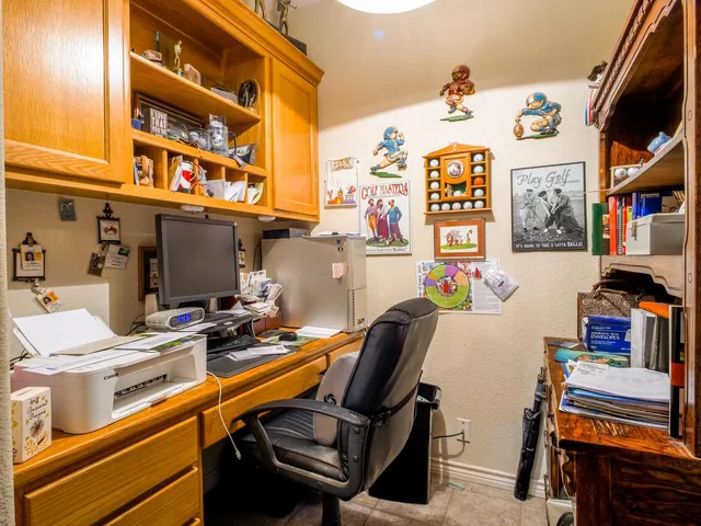 a work place with computer on a desk and chair