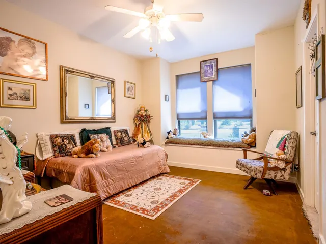 a bed sitting in a bedroom next to a window
