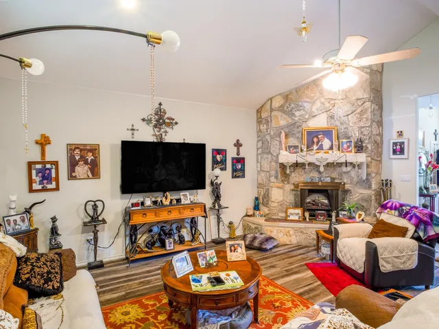 a living room with fireplace furniture and a flat screen tv