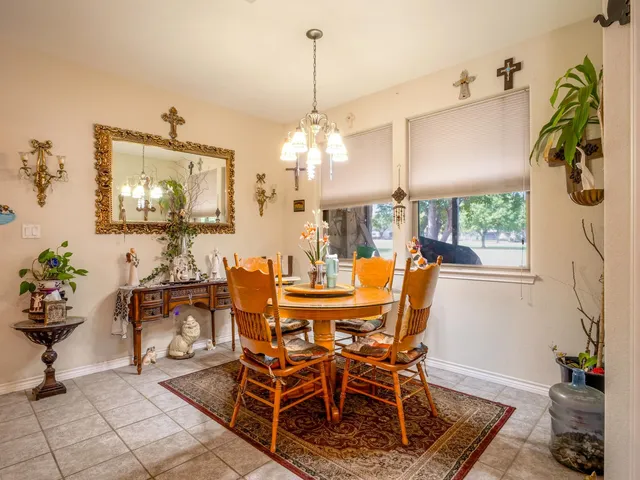 a view of a dining room with furniture and chandelier
