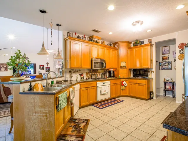 a kitchen with stainless steel appliances granite countertop a sink and cabinets