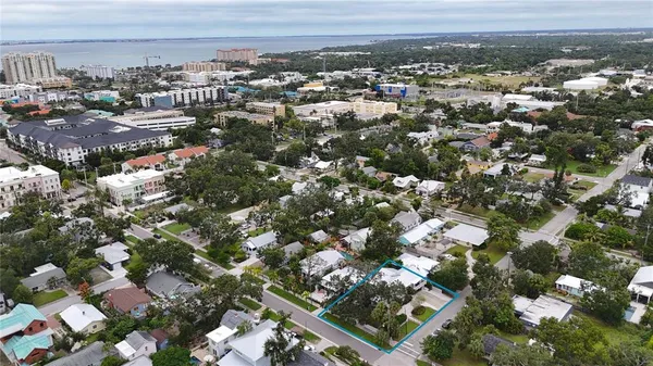 an aerial view of a house with a yard and lake