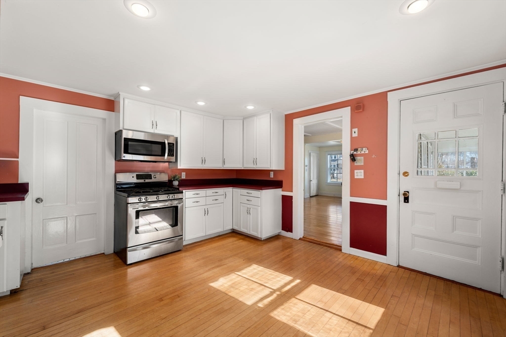 278 North Main Street Natick, MA 01760 - Photo 5 of 28 a kitchen with stainless steel appliances granite countertop a refrigerator and a stove top oven
