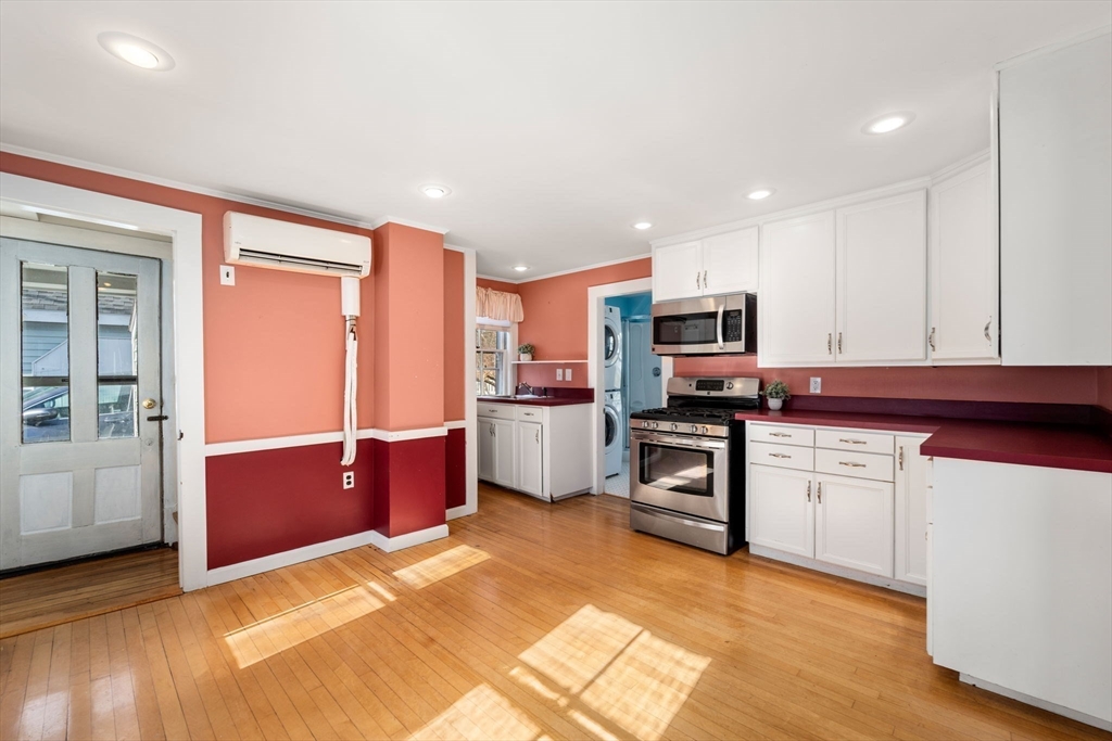 278 North Main Street Natick, MA 01760 - Photo 7 of 28 a kitchen with stainless steel appliances granite countertop a refrigerator and a stove top oven