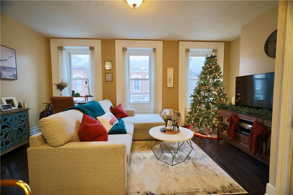 515 Lockhart Street, Unit 3 Pittsburgh, PA 15212 - Photo 5 of 27 a living room filled with furniture and a flat screen tv