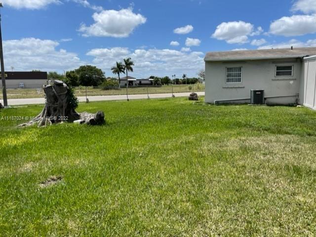 22365 Southwest 112th Court Miami, FL 33170 - Photo 5 of 6 a backyard of a house with table and chairs