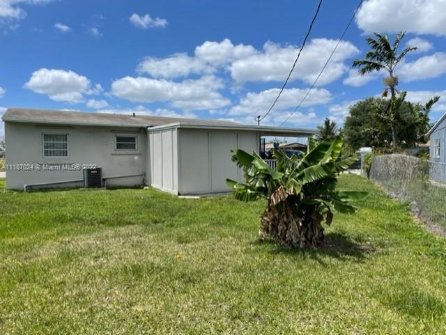 22365 Southwest 112th Court Miami, FL 33170 - Photo 6 of 6 a backyard of a house with table and chairs