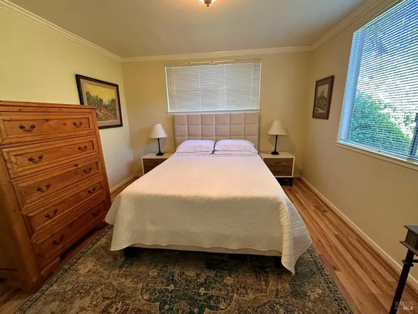 a bed sitting in a bedroom next to a window