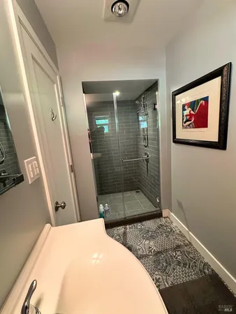 a bathroom with a sink toilet and a mirror