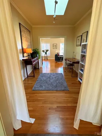 a living room with furniture and a book shelf