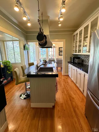 a kitchen with stainless steel appliances kitchen island granite countertop a sink and cabinets